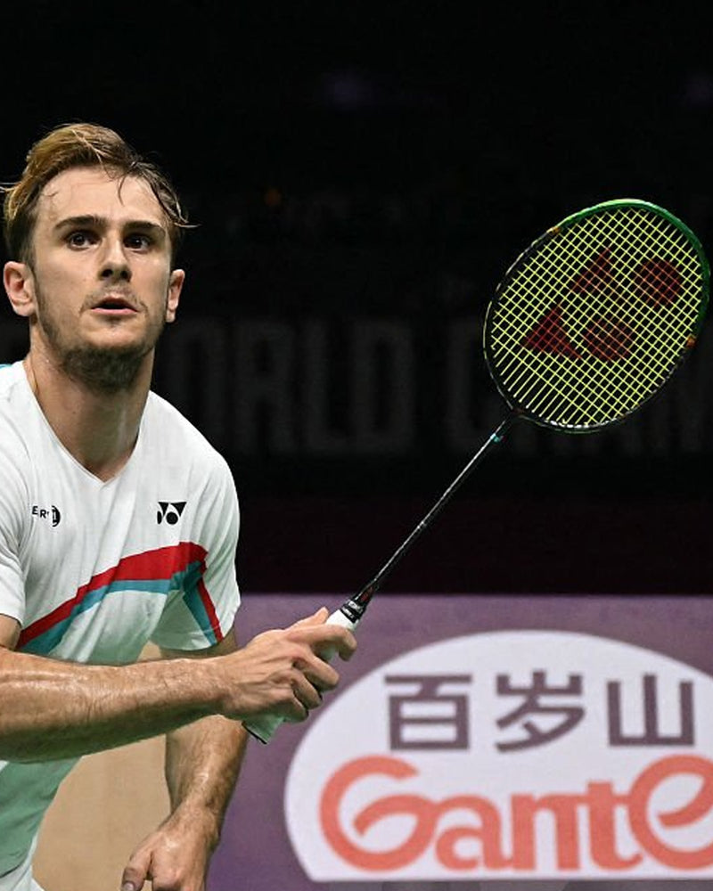 Alex Lanier on court holding his Yonex racket