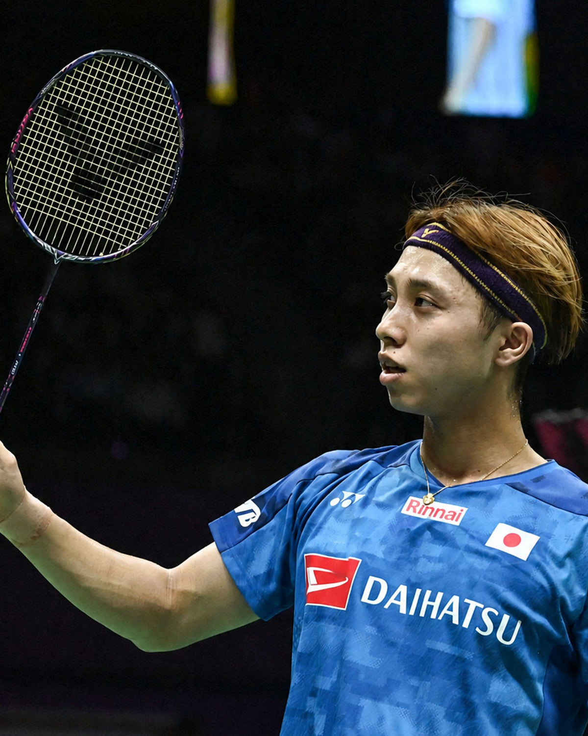 Kodai Naraoka on court holding his Victor racket