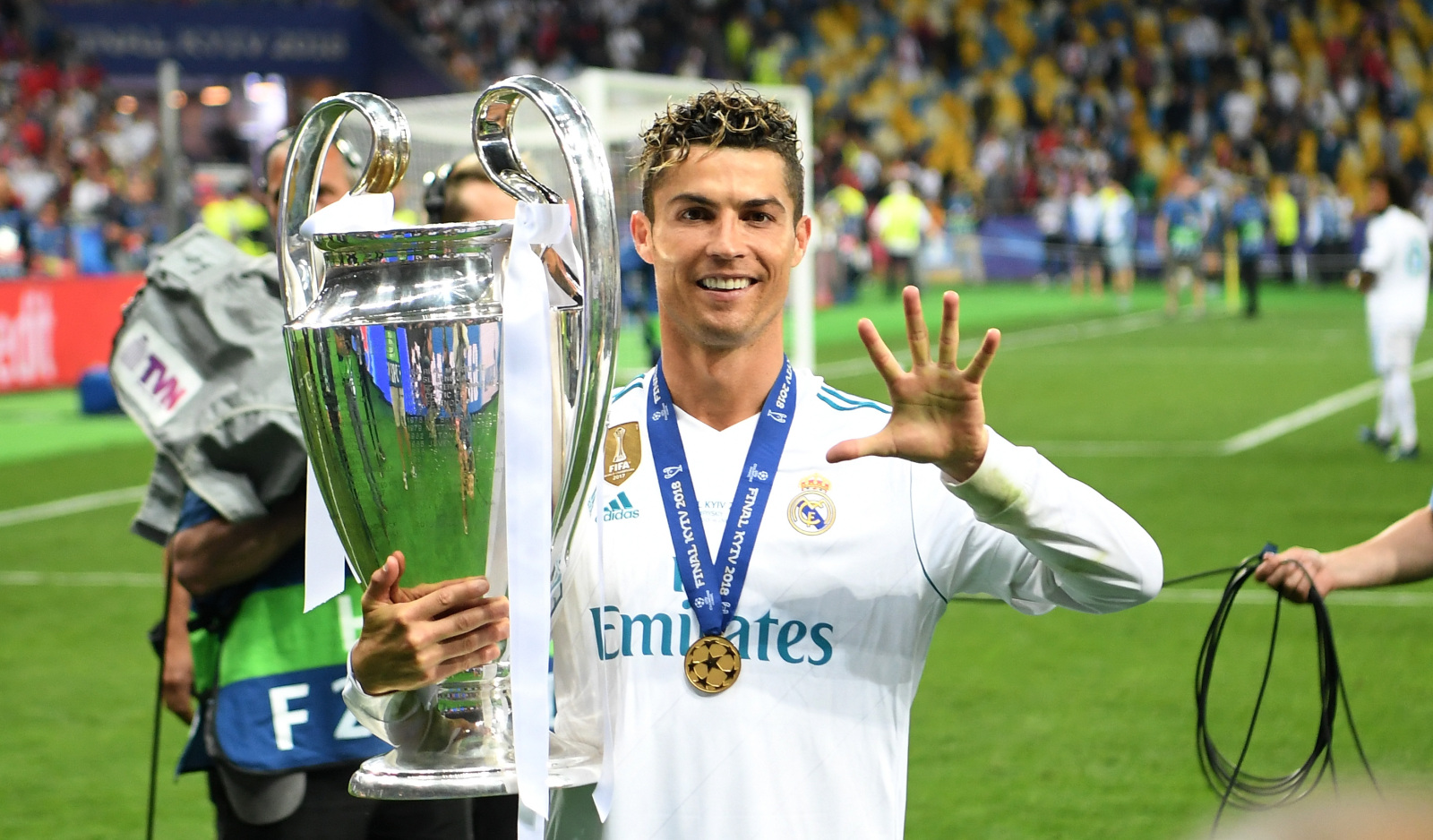 Ronaldo for Real Madrid holding a cup in hand