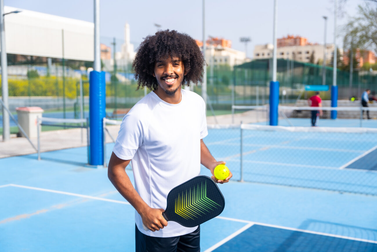 A man holded pickleball paddle